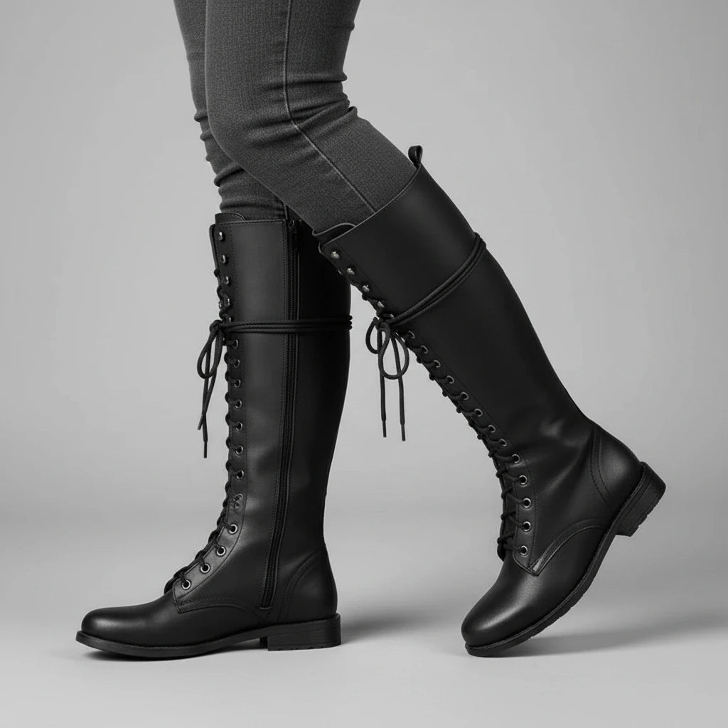 Valelus Mia Studded Lace-Up Knee-High Boots in Black, side walking view on model
