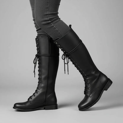 Valelus Mia Studded Lace-Up Knee-High Boots in Black, side walking view on model