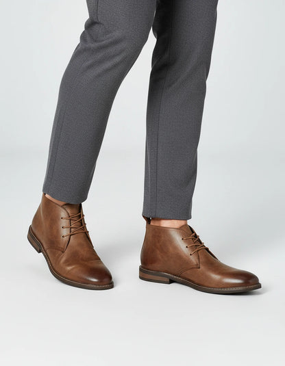 Valelus Muhammad Full-Grain Leather Chukka Boots in Dark Brown, side walking view on model